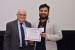 Dr. Nagib Callaos, General Chair, giving Mr. Arjun Singar the best paper award certificate of the session "Education, Training and Informatics II." The title of the awarded paper is "Relations between Learning Styles and Learning Methods for the Internet of Things Knowledge Areas amongst Engineering Students."